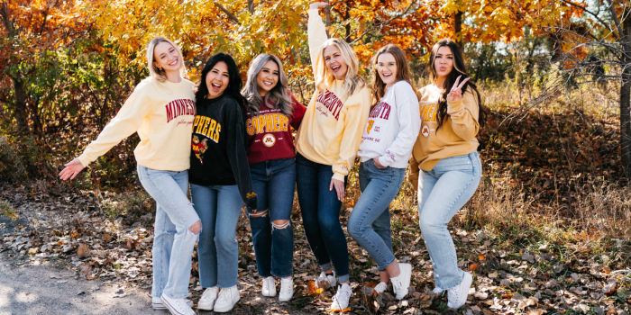 Group photo of girls in fall wearing University of Minnesota crew neck sweatshirts with fleece lining and maroon and gold screenprinted detail