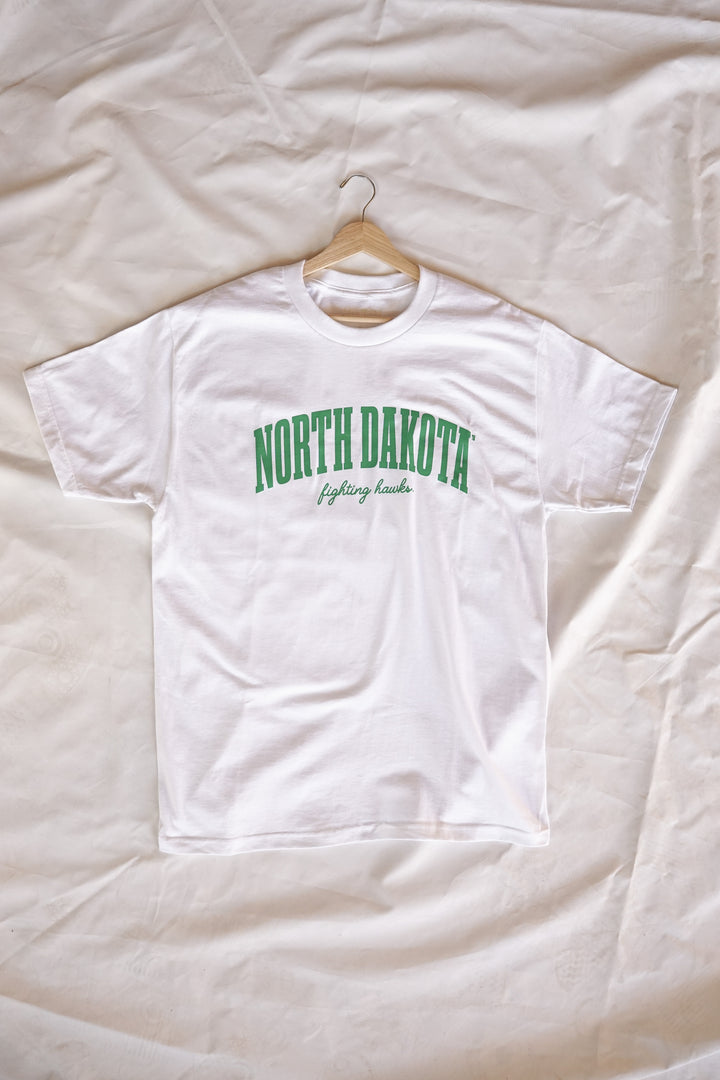 image of a white tshirt on a hanger laying on a white back drop and the tshirt is screenprinted with North Dakota Fighting Hawks in green