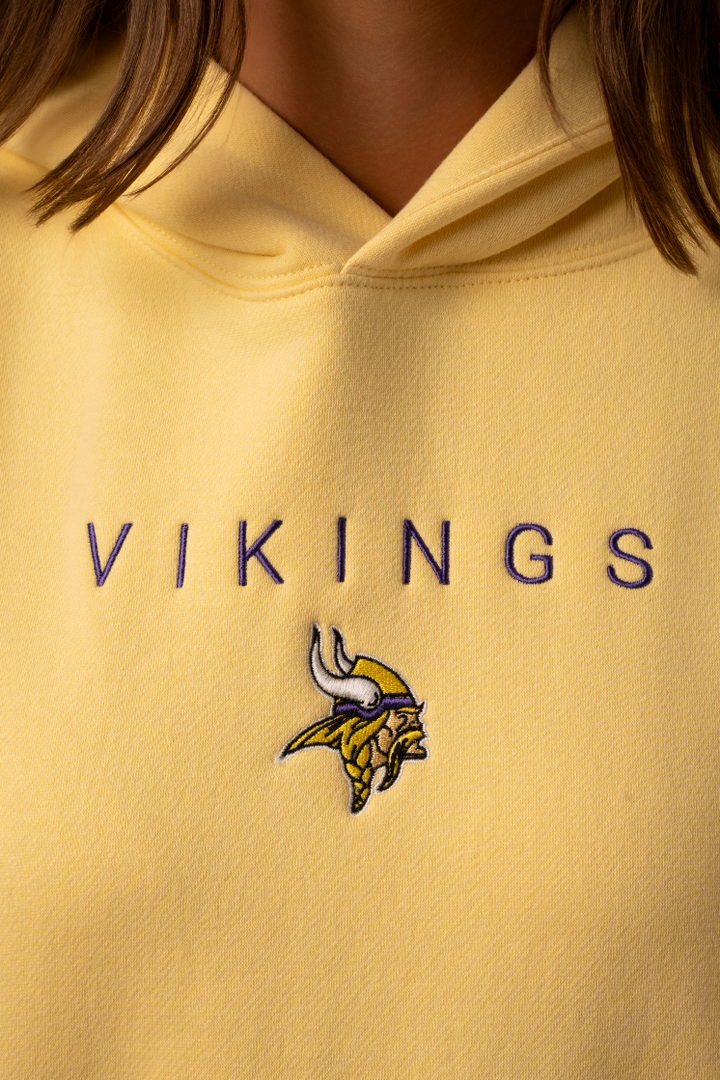 A Yellow hoodie with purple 'Vikings' text and a small Vikings logo in the center
