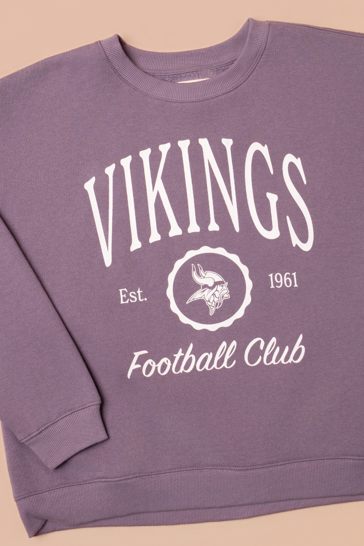 Purple crew neck sweatshirt with white 'Vikings Football Club' and 'EST 1961' text and a white Vikings logo in the center