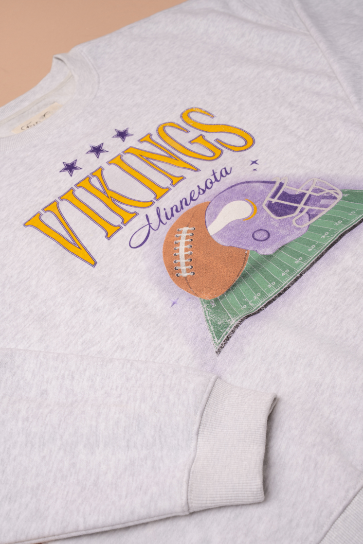 Heather grey crew neck sweatshirt with large yellow 'Vikings' text, purple 'Minnesota' cursive text and a football and helmet graphic under it