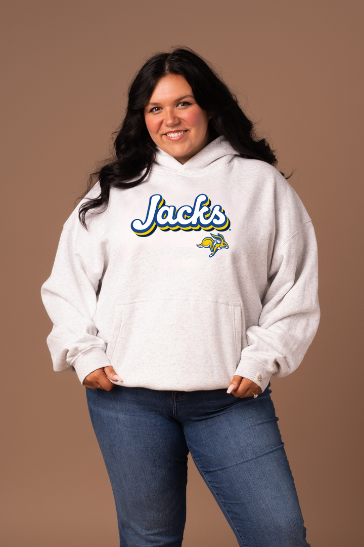 Woman wearing a heather grey hoodie with 'Jacks' text and a Jackrabbit logo
