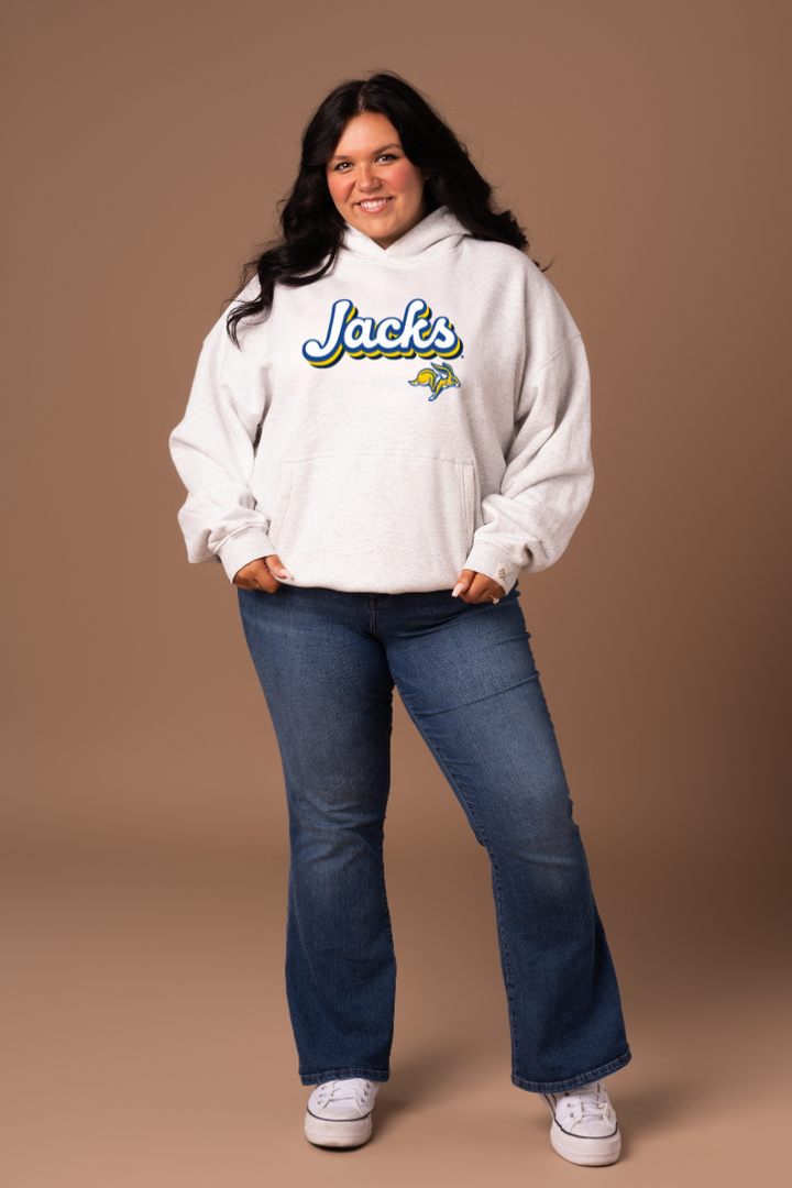 Woman wearing a heather grey hoodie with 'Jacks' text and a Jackrabbit logo
