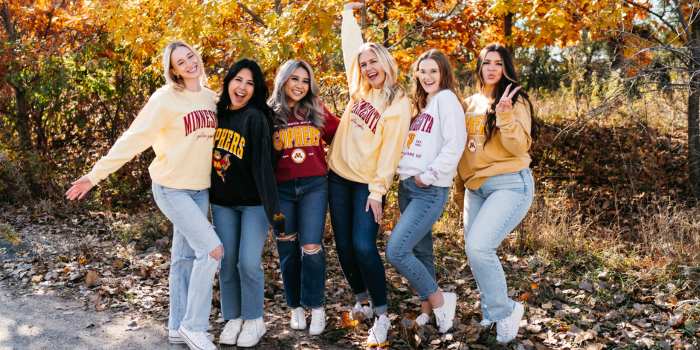 Group photo of girls in fall wearing University of Minnesota crew neck sweatshirts with fleece lining and maroon  and gold screenprinted detail