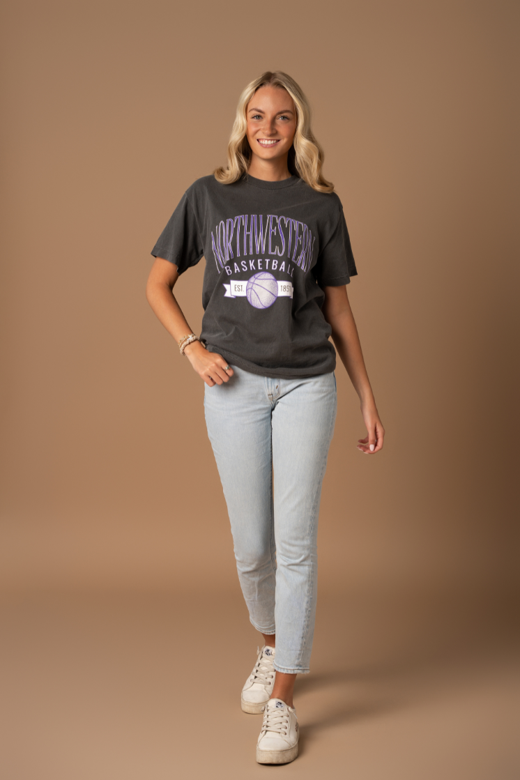 picture of a girl wearing a faded black cotton t-shirt that is vintage inspired with Northwestern University basketball screenprinted details