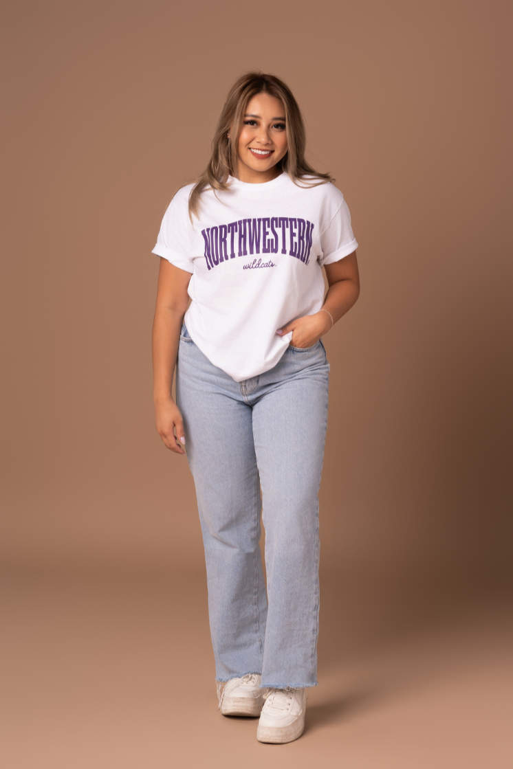 picture of a girl wearing a white cotton t-shirt with purple Northwestern Wildcats screenprinted details 