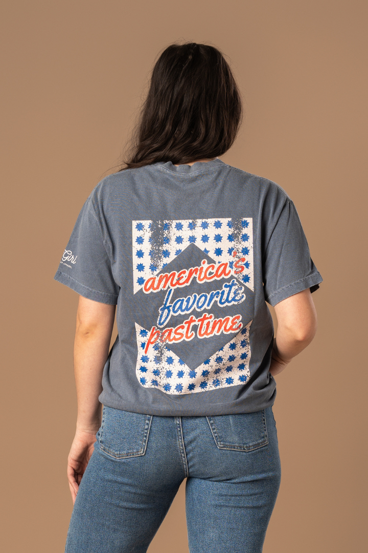 picture of the backside of a girl wearing a faded navy tee with red, cream, and blue vintage and worn-in inspired design 