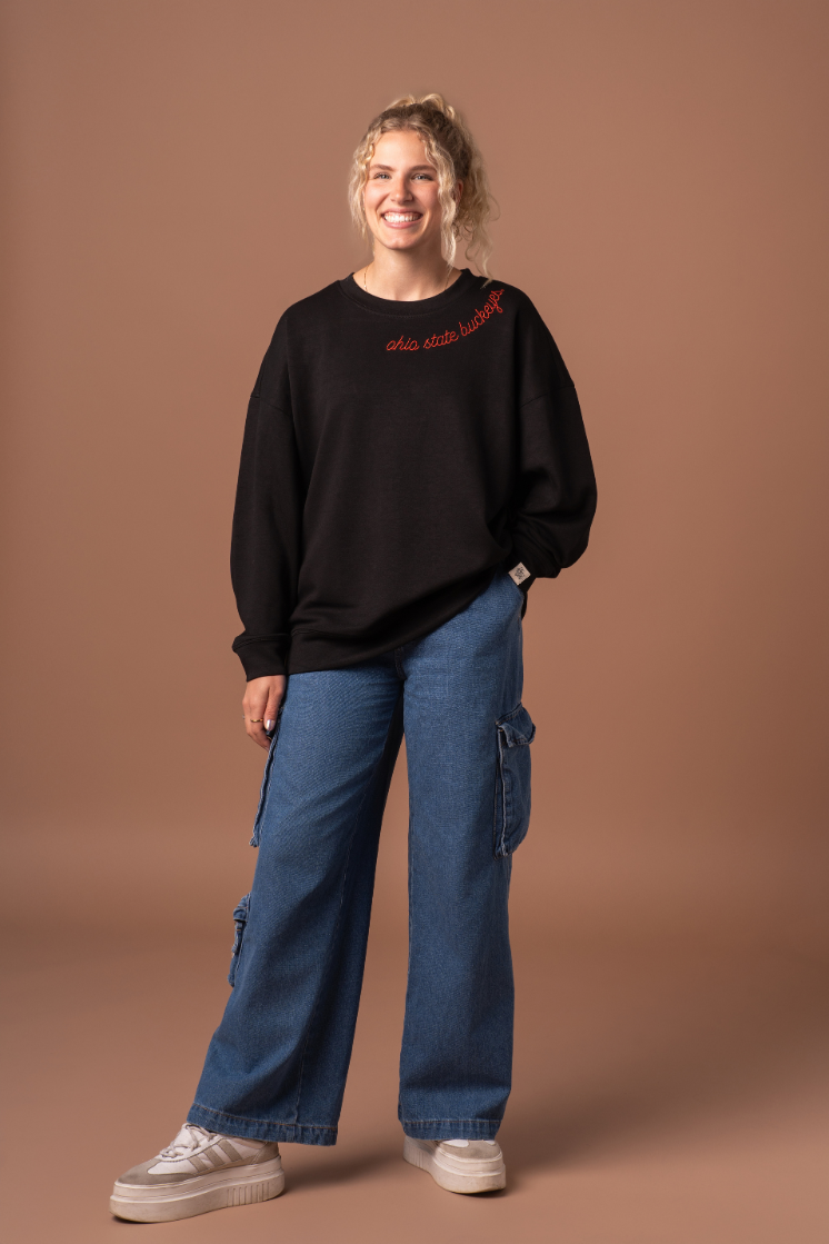 picture of a girl wearing a black Buckeyes Supersoft Crew Neck with red embroidery detail 