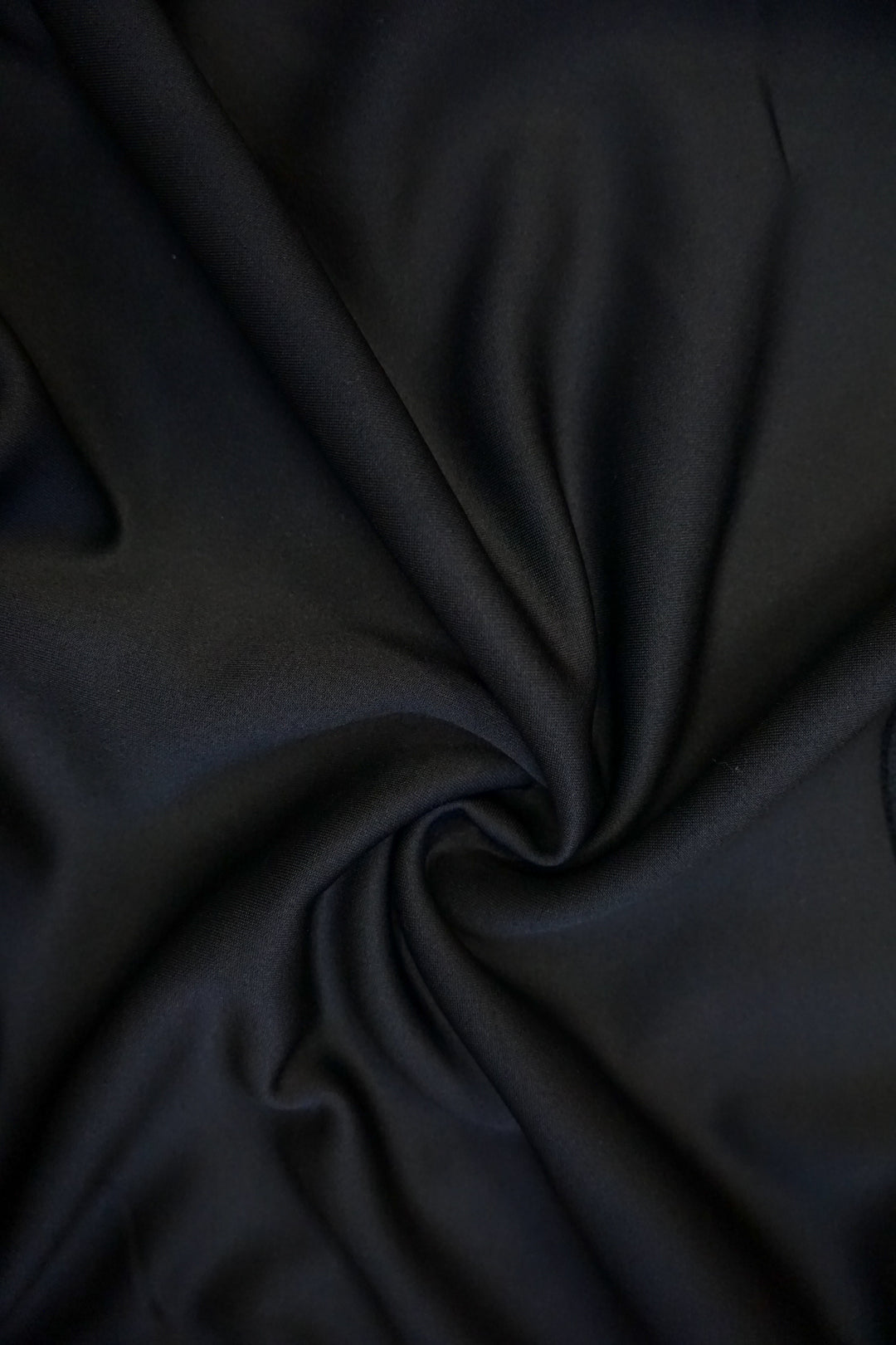 close up of the material of a black supersoft crew neck