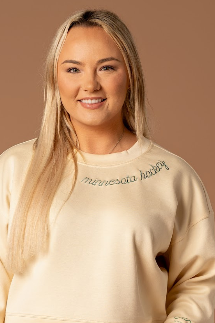 close up of embroidered very soft ivory crew neck athleisure sweatshirt that says minnesota hockey