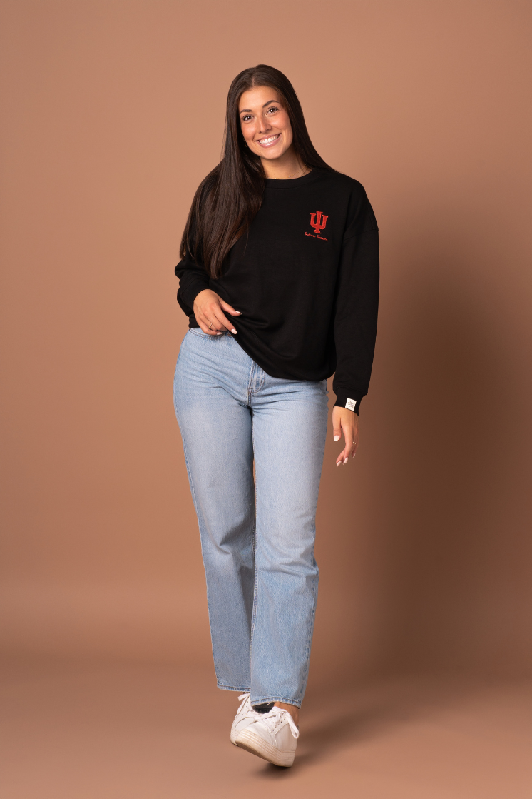 a zoomed out picture of a girl in Hoosiers Supersoft Crew Neck, super soft black athlesiure material with a crimson embroidered University of Indiana logo