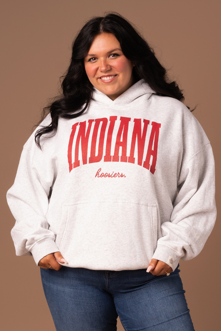 a close up of a girl wearing a Indiana University Hoodie with a ash gray oversized, screenprinted, fleece-lined sweatshirt with a crimson design