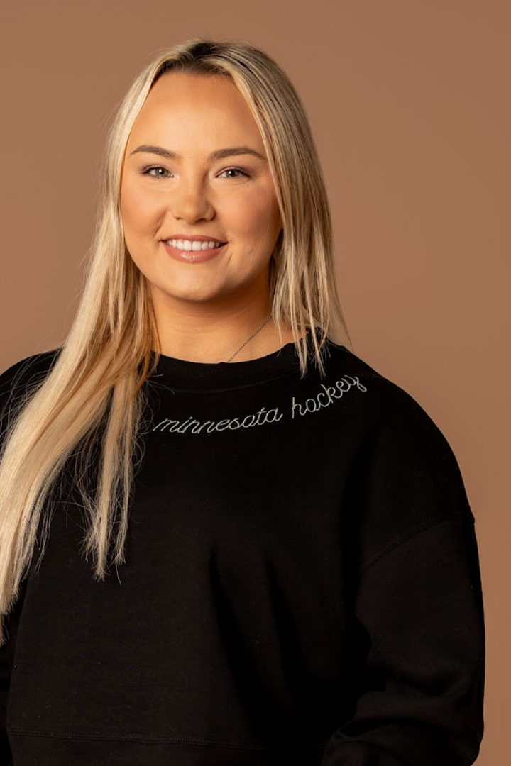 close up of embroidered very soft black crew neck athleisure sweatshirt that says minnesota hockey