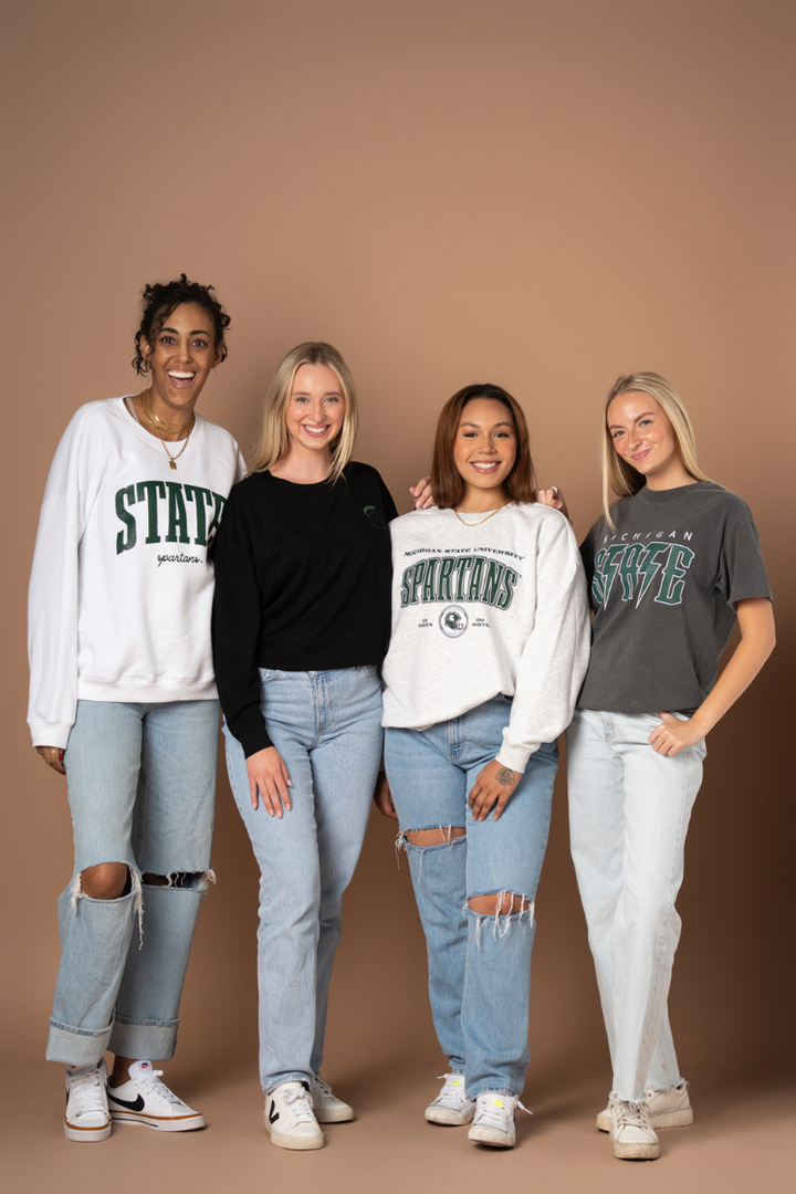 picture of four girls wearing Michigan State University apparel by Fan Girl