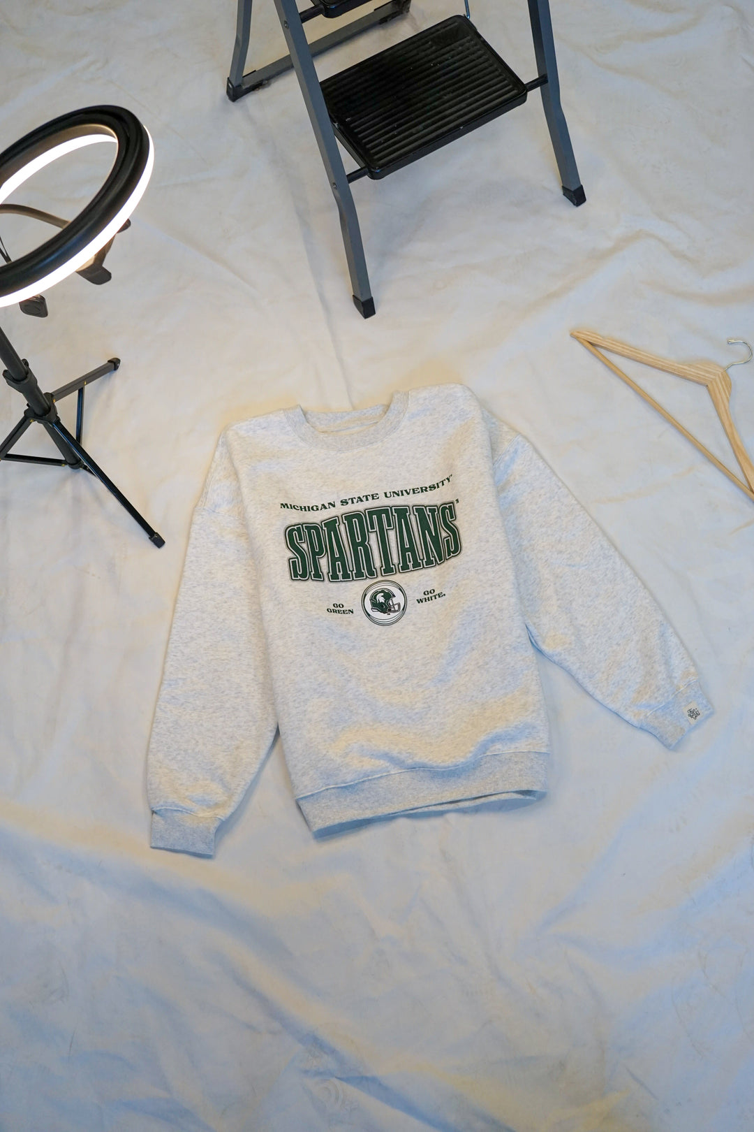 picture of a ash gray fleece lined Michigan State University Vintage Oversized Crew Neck sweatshirt with a green, black, and white screenprinted design