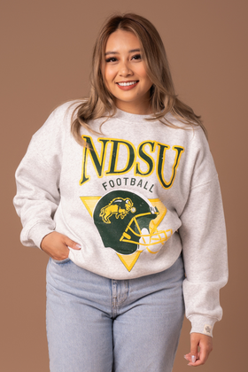 close up of girl wearing ndsu throwback football crew with hand in pocket.