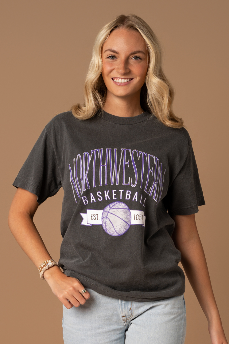 close up of a girl wearing a faded black cotton t-shirt that is vintage inspired with Northwestern University basketball screenprinted details