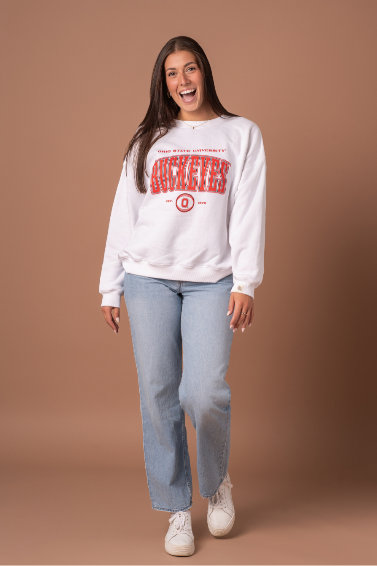 picture of a girl wearing a white, fleece lined Ohio State University Vintage Oversized Crew Neck with red and black screenprinted detail