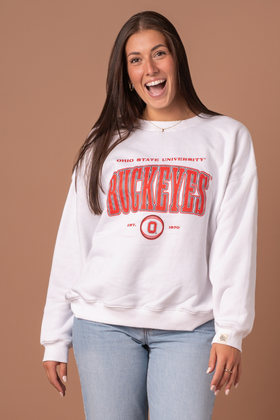 close up picture of a girl wearing a white Ohio State University Vintage Oversized Crew Neck with red and vintage screenprinted detail