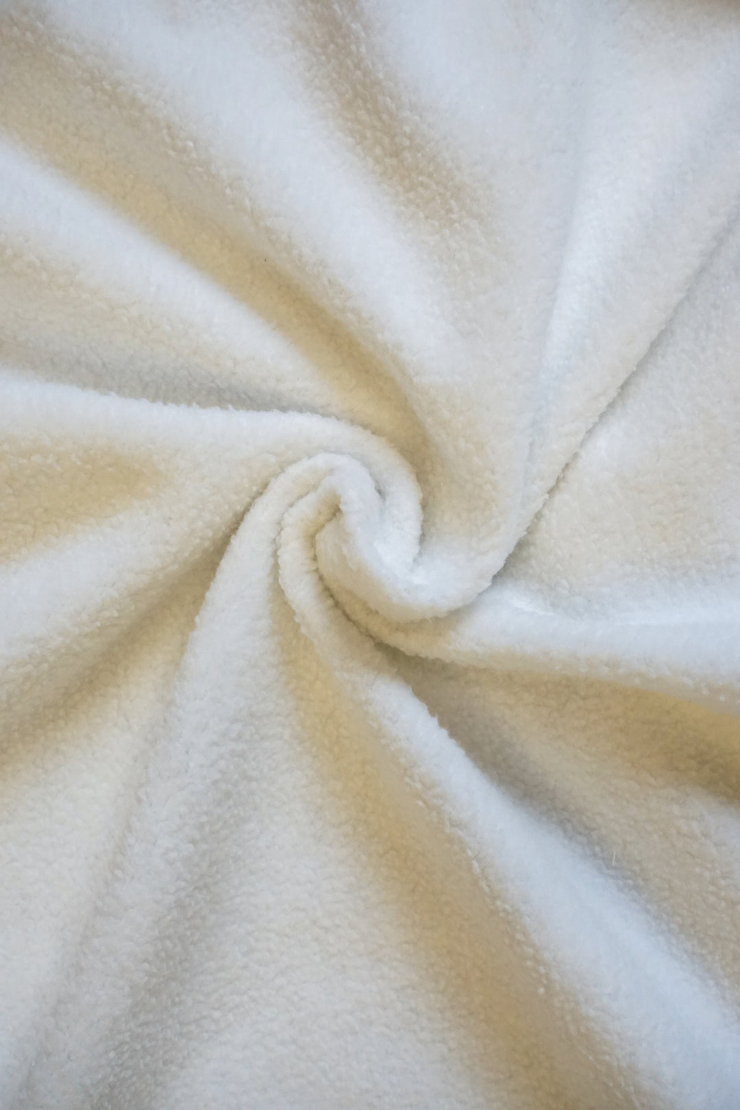 close up of the inside of a white fleece lined crew neck sweatshirt