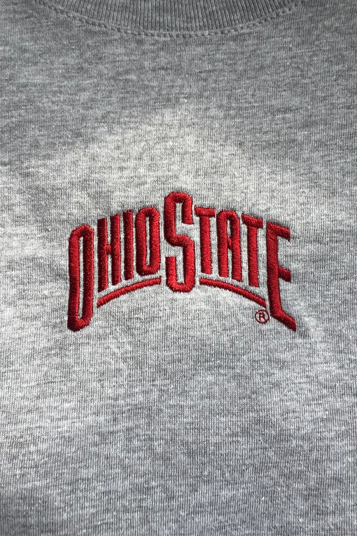Close up of a gray t-shirt with a red embroidered  'OHIO STATE' logo