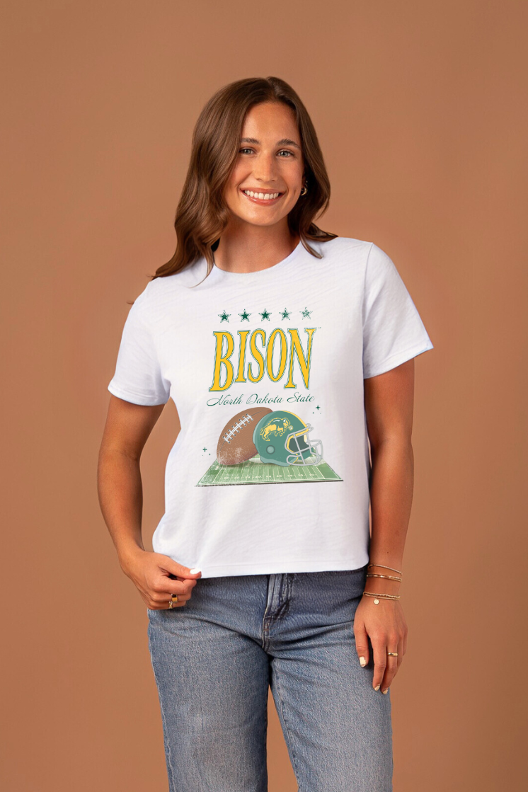 a girl wearing a white boxy tee with "Bison" written on it with a field and football graphic