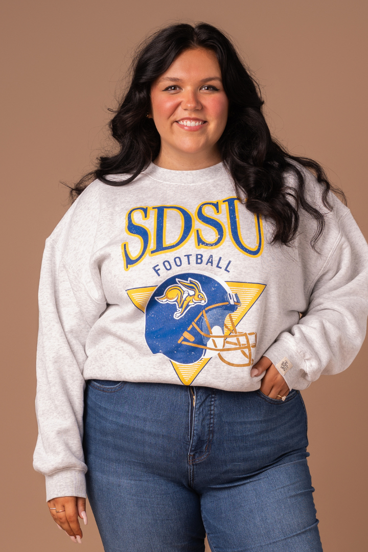 close up image of a girl wearing an ash gray crew with a SDSU football helmet logo screenprinted in blue and yellow