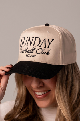 Close up of a girl wearing a trendy game day hat that has embroidered design on it that say s 