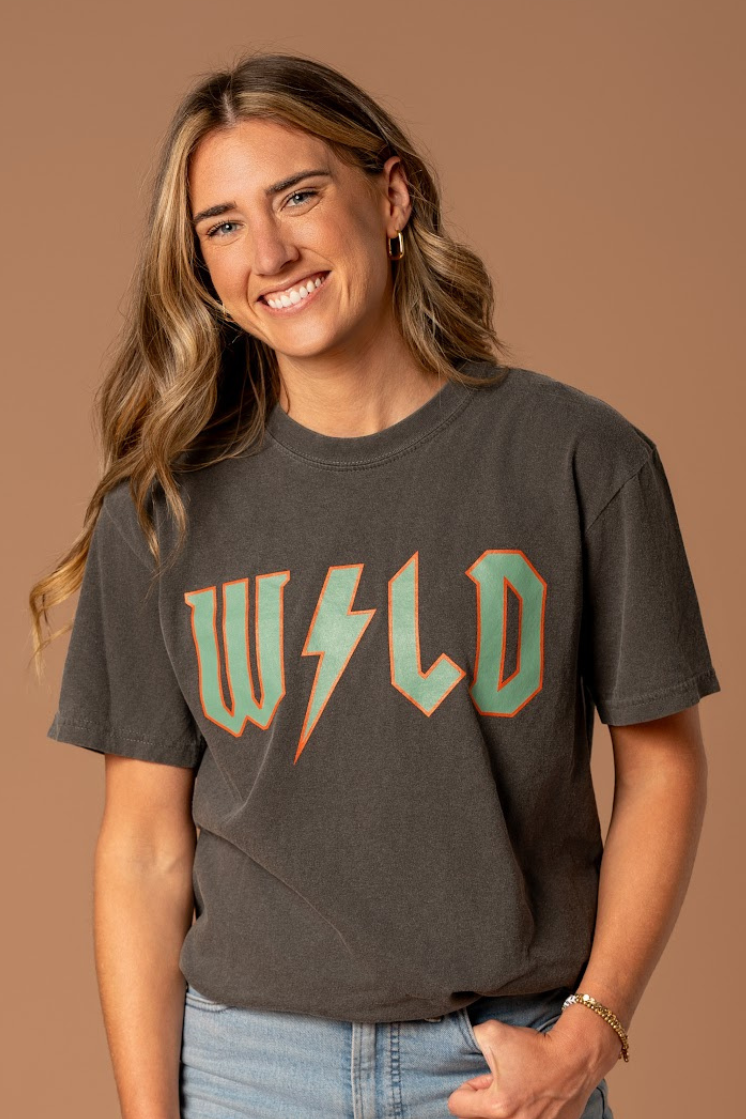 woman in a trendy hockey wild band tee black and retro