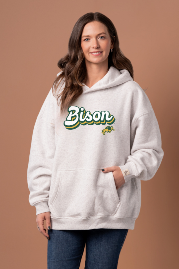 Women wearing a heather grey hoodie with 'Bison' text and a Bison logo under it 