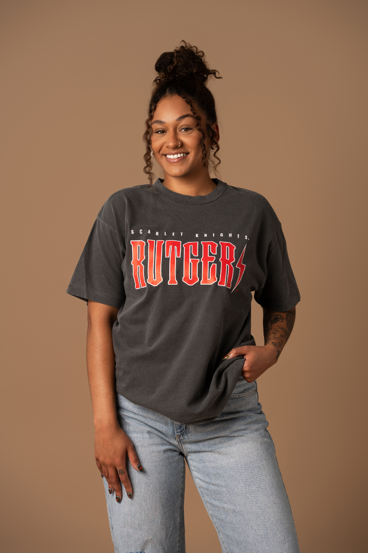 woman wearing a faded black cotton t-shirt with white and red 'scarlet Knights Rutgers' text