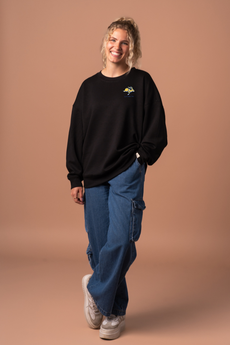 Woman wearing a black crew neck sweatshirt with a small Jackrabbit logo