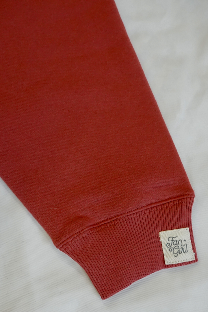 maroon sweatshirt sleeve with a 'Fun Girl' label on a white background