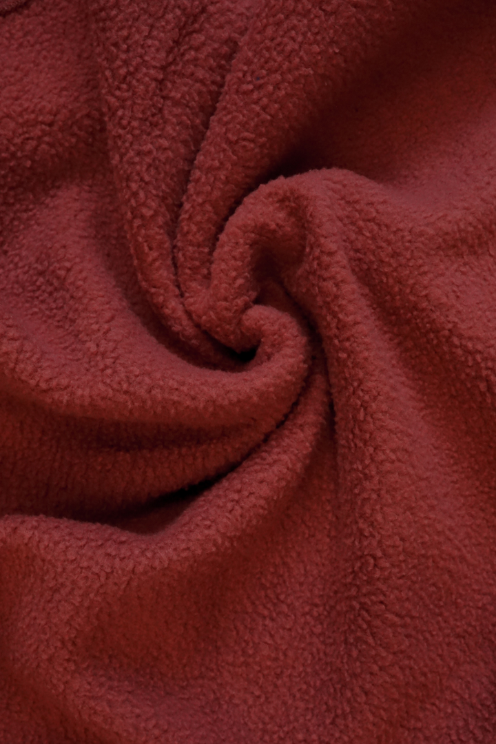 Close-up of maroon textured fabric, soft