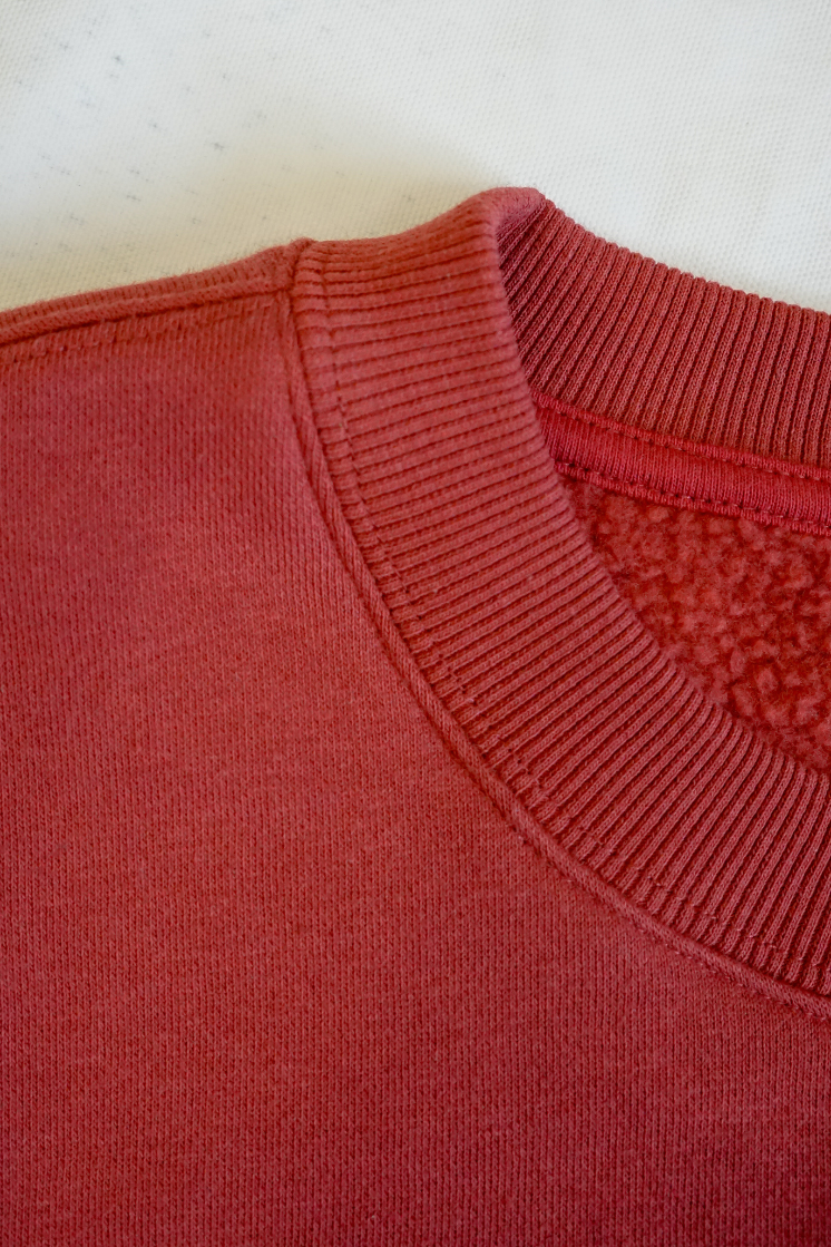 Close-up of a maroon crew neck collar