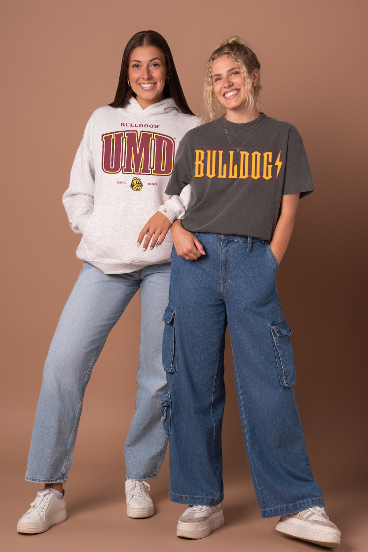 Two people wearing bulldog-themed clothing against a brown background