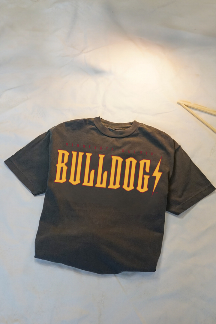 Ash grey t-shirt with 'Bulldogs' printed in yellow and maroon folded on a white background