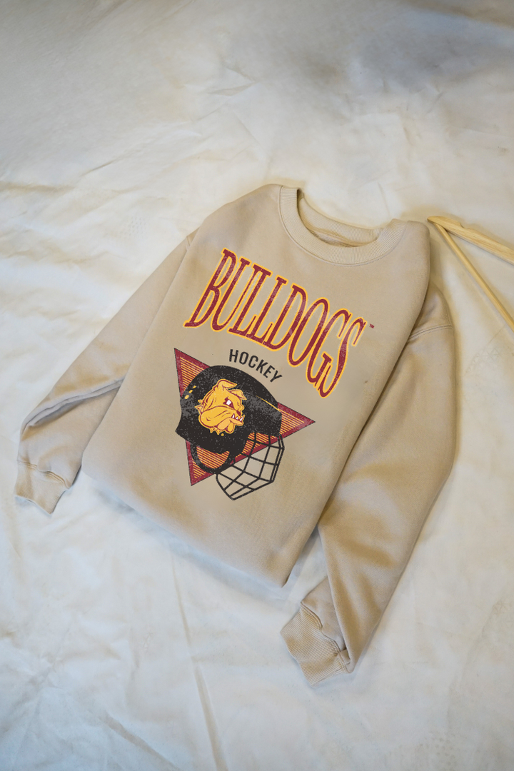 Beige sweatshirt with 'Bulldogs Hockey' text and logo on a light background