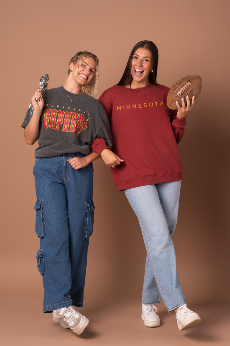 Two women wearing Minnesota-themed apparel